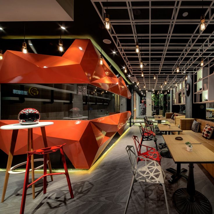 Modern Cafe Design Featuring Vibrant Geometric Walls and Versatile Seating