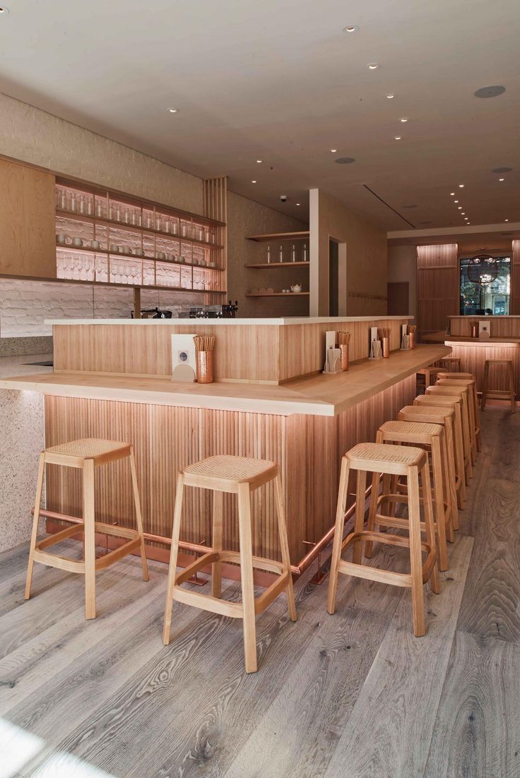 Modern Minimalist Cafe Design with Inviting Wooden Elements and Communal Atmosphere