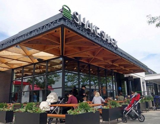 Contemporary Cafe with Inviting Wooden Trellis Roof and Communal Outdoor Seating