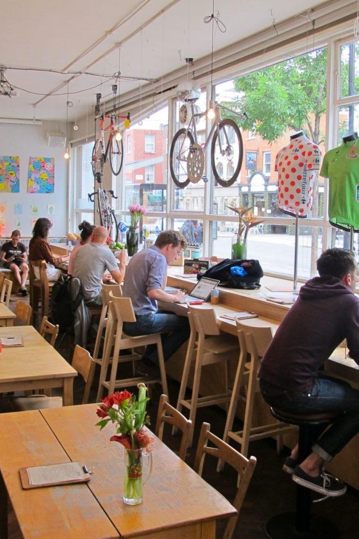 Bright and Inviting Cafe: A Warm, Interactive Space Enhanced by Creative Decor and Natural Light