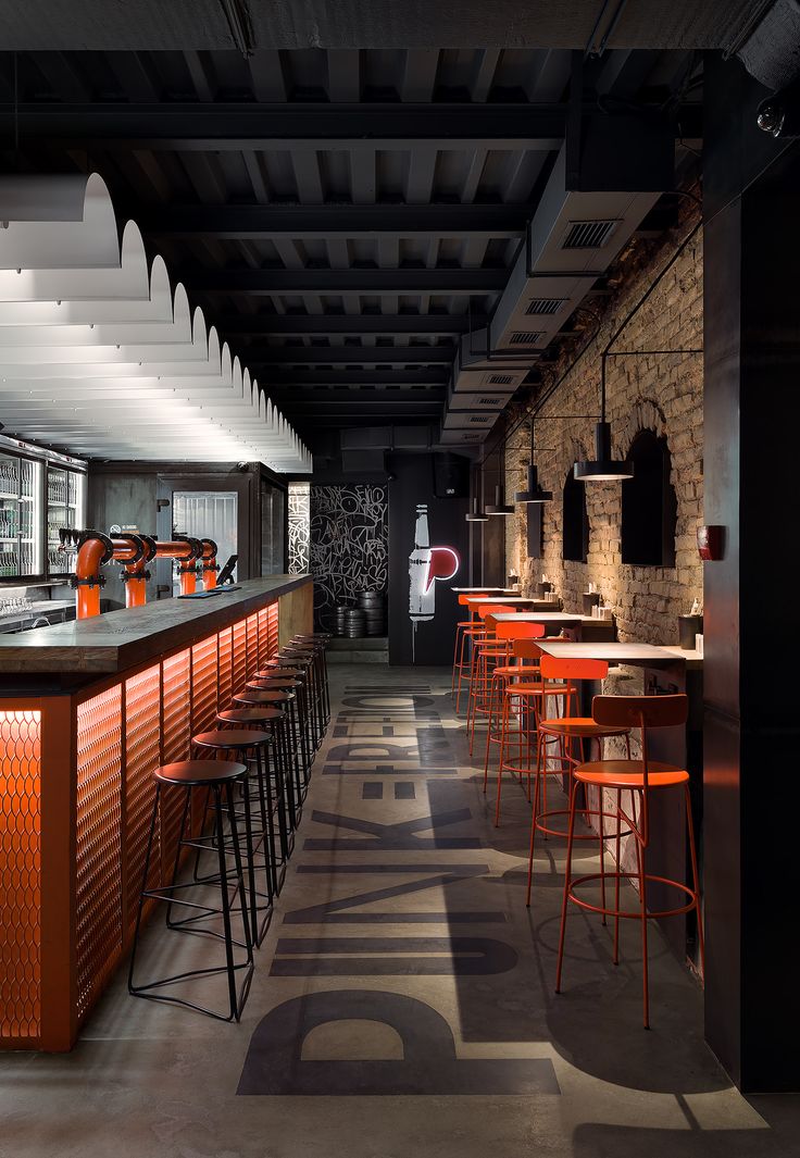 Modern Industrial Cafe Design with Striking Orange and Black Aesthetic