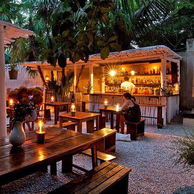 Charming Cafe Design: An Inviting Outdoor Space with Rustic Elements and Lush Greenery