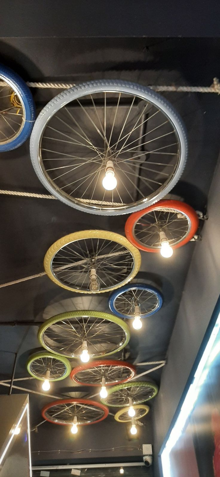 Whimsical Cafe Design Showcases Colorful Bicycle Wheel Light Fixtures