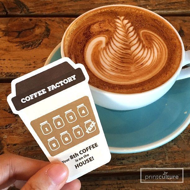 Charming Cafe Ambiance with Artistic Latte and Engaging Loyalty Card