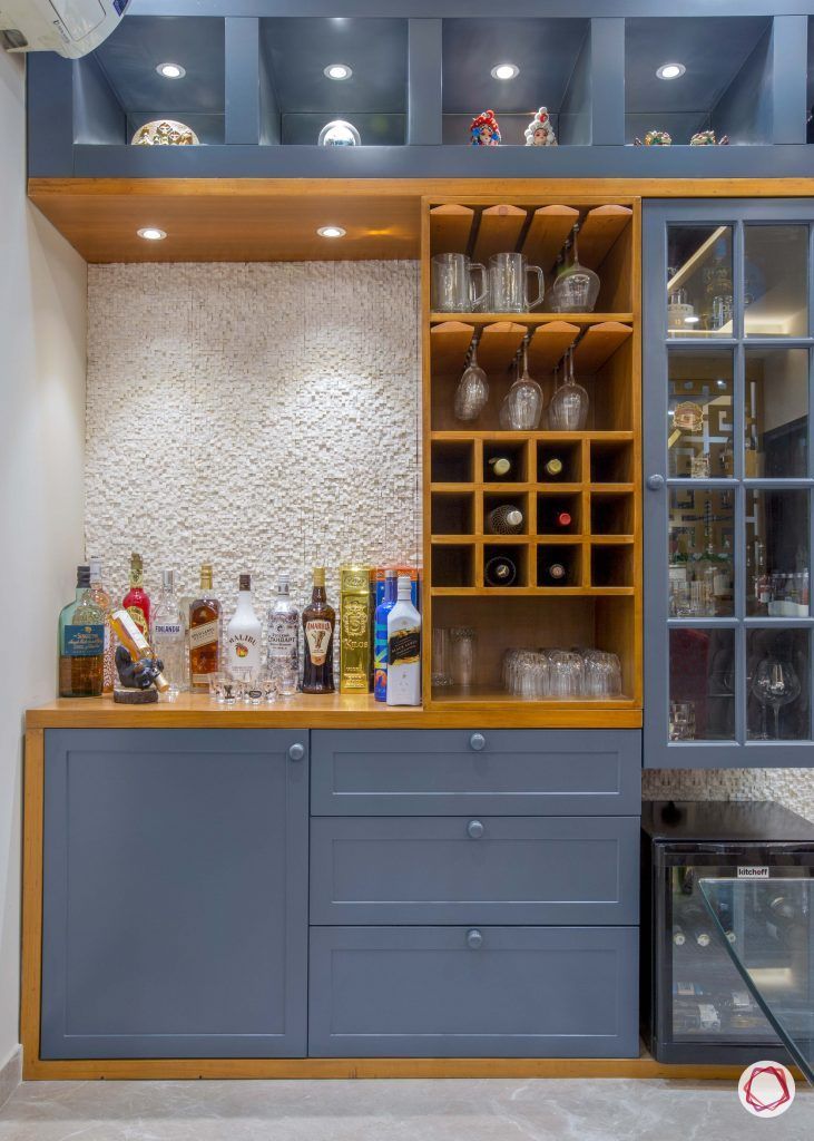 Elegant Cafe Bar Design: Deep Blue Cabinetry, Warm Wood Accents, and Textured Stone Wall Create a Stylish Focal Point