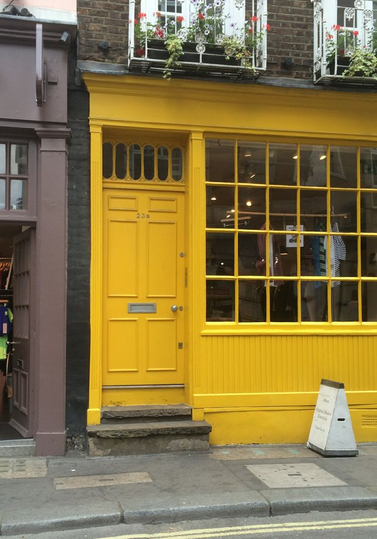 Charming Cafe Design with Striking Yellow Facade and Inviting Atmosphere