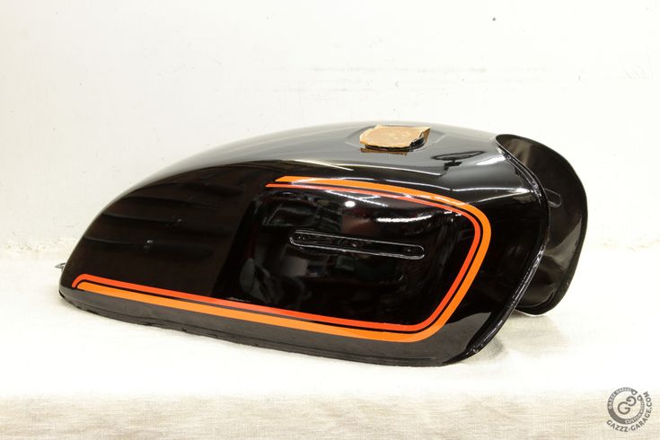 Stylish Aerodynamic Motorcycle Fuel Tank with Glossy Black Finish and Orange Accents