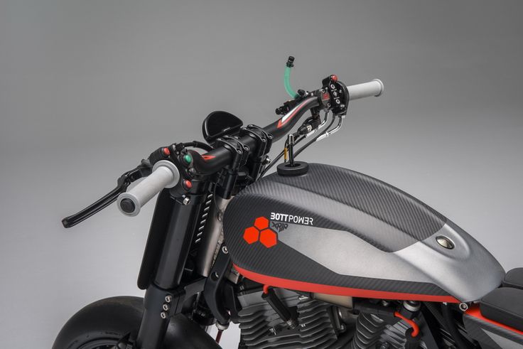 Close-Up of a Sleek, Modern Motorcycle Highlighting Minimalist Handlebars and Durable Carbon-Fiber Tank