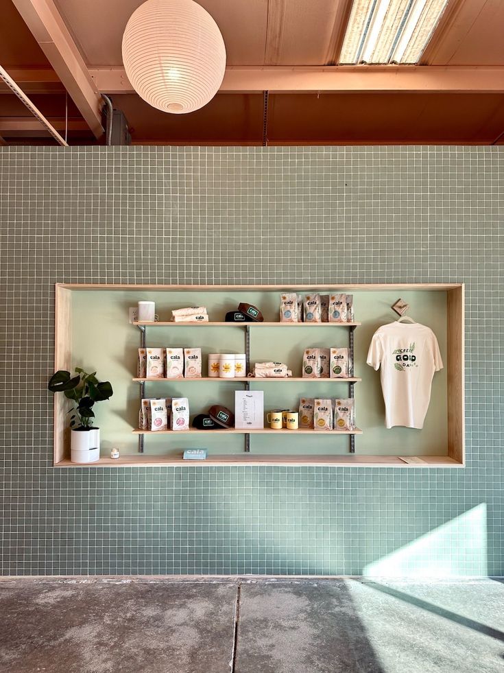 Contemporary Cafe Design: Minimalist Aesthetic with Inviting Green Tiled Wall and Thoughtful Layout