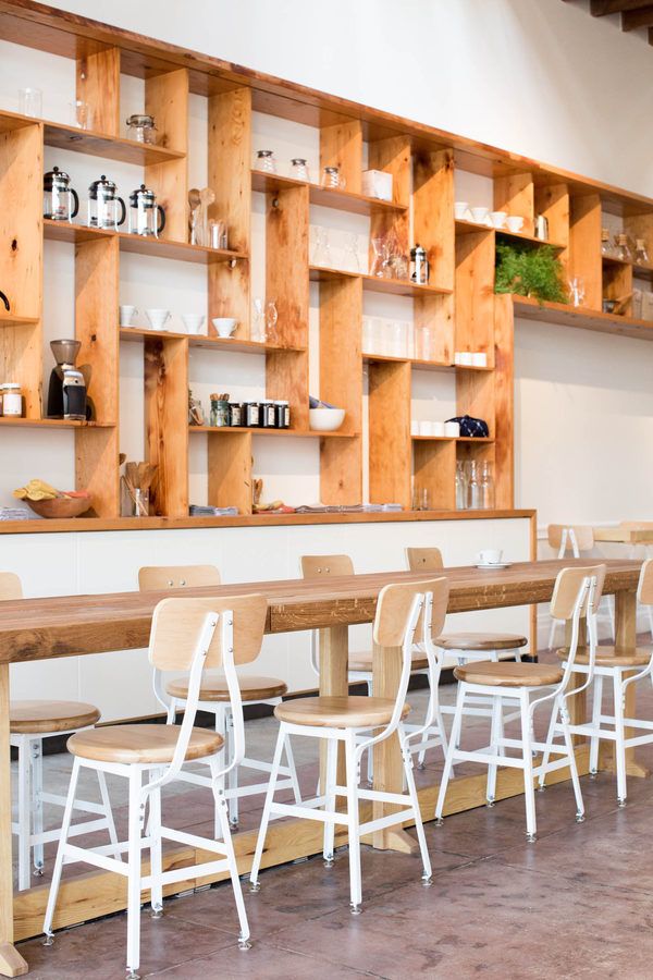 Modern Minimalist Cafe Design with Warm Wooden Elements and Communal Atmosphere