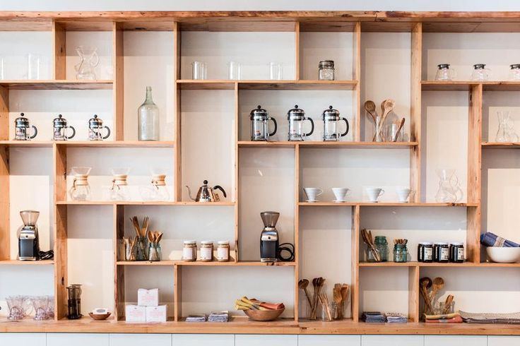 Stunning Modular Wooden Shelving Enhances Functional Aesthetics in Cozy Cafe Design