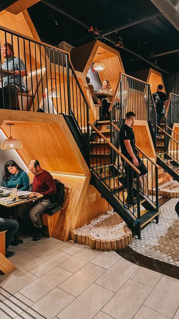 Chic Multi-Level Cafe Design Enhances Intimacy with Cozy Hexagonal Seating and Natural Elements