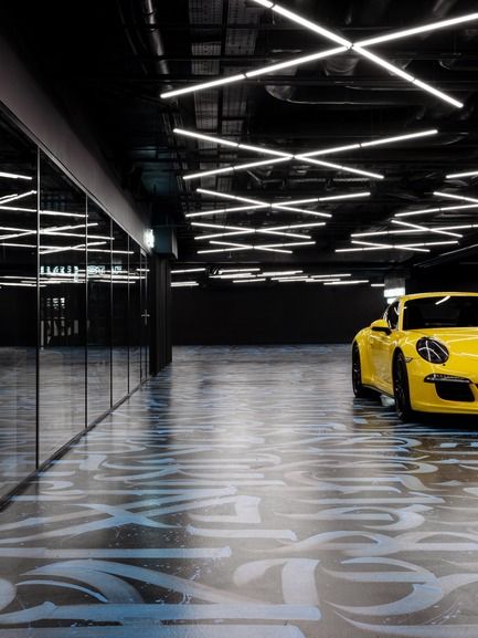 Modern, Stylish Interior Design Featuring a Striking Yellow Car and Dynamic Lighting