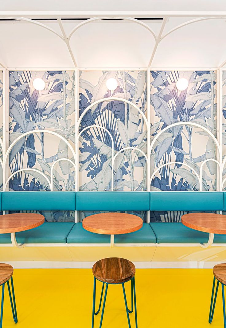 Vibrant Cafe Design with Botanical Wallpaper and Whimsical Touches