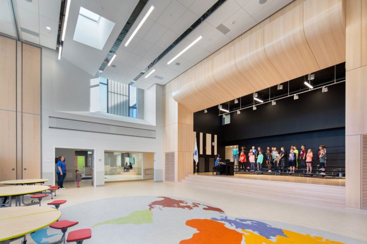 Modern Interior Space with Inviting Design: High Ceilings, Natural Light, and Flexible Seating for Community Engagement