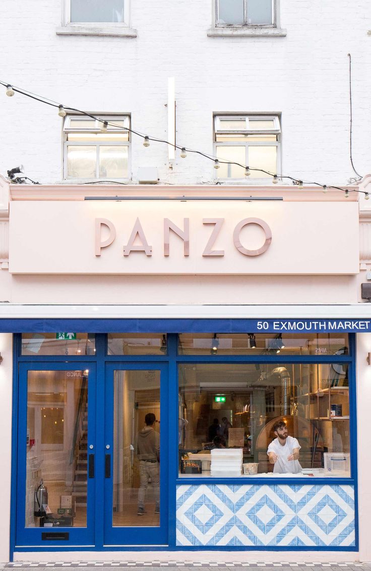 Modern Cafe with Inviting Pink Facade and Artistic Tile Entrance