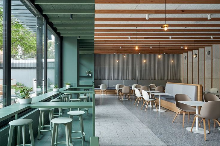 Modern Cafe Design: Inviting Atmosphere with Earthy Tones and Versatile Seating