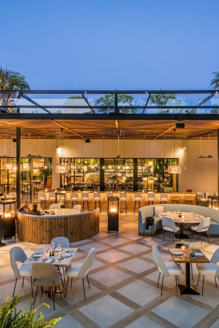 Inviting Cafe Design Blends Indoor-Outdoor Elements with Stylish Aesthetics and Natural Light