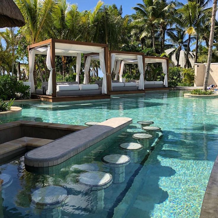 Serene Tropical Oasis with Elegant Cabanas and Unique Stone Pathways