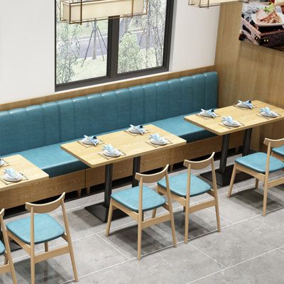 Contemporary Cafe Design: Cozy Teal Bench, Inviting Atmosphere, and Natural Light