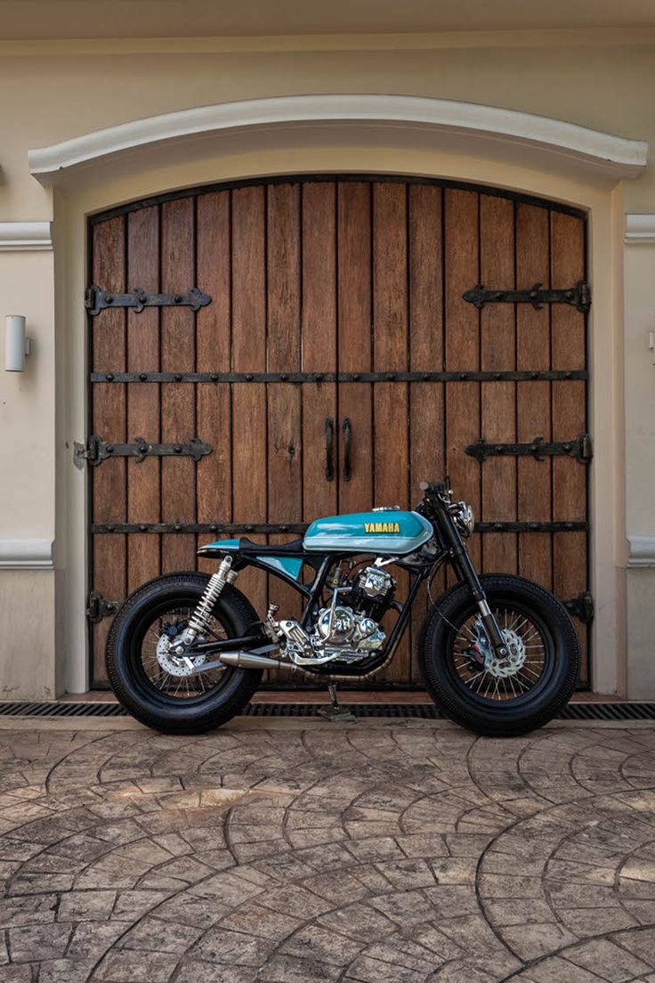 Elegant Motorcycle Meets Rustic Charm: A Visual Harmony of Modern Design and Traditional Architecture