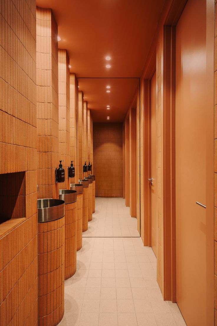 Warm and Welcoming Cafe Restroom Design with Earthy Tones and Modern Fixtures