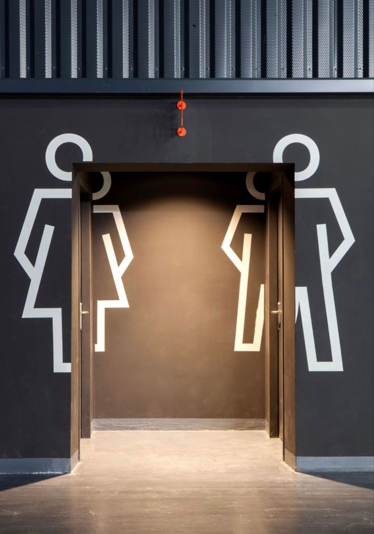 Stylish Minimalist Restroom Entrance Design with Bold Figures and Warm Details