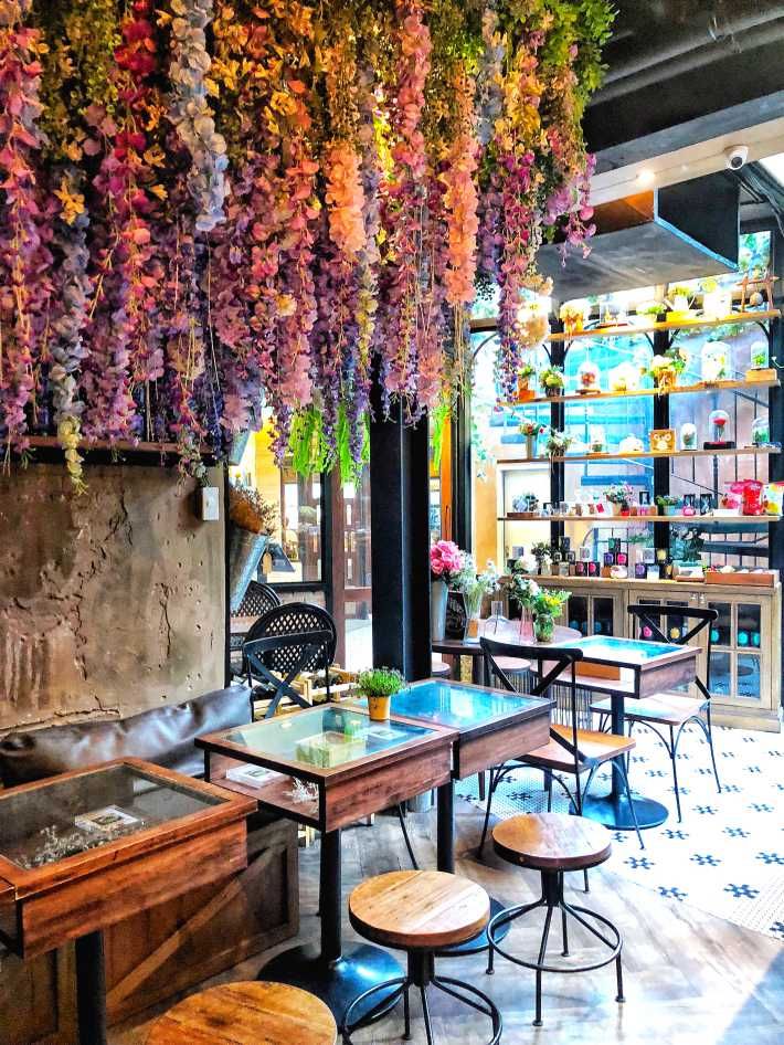 Charming Cafe with Whimsical Floral Decor and Cozy Rustic Ambiance