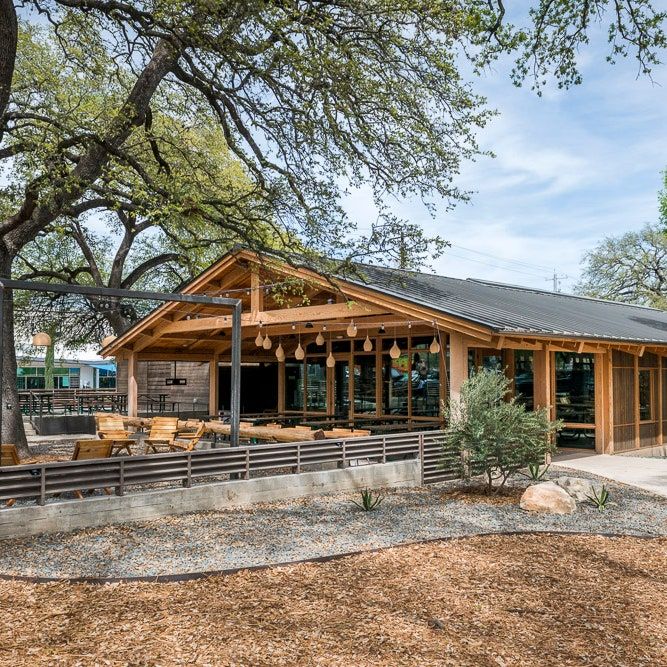 Charming Modern Cafe Design Integrates Wood, Glass, and Nature for a Welcoming Atmosphere