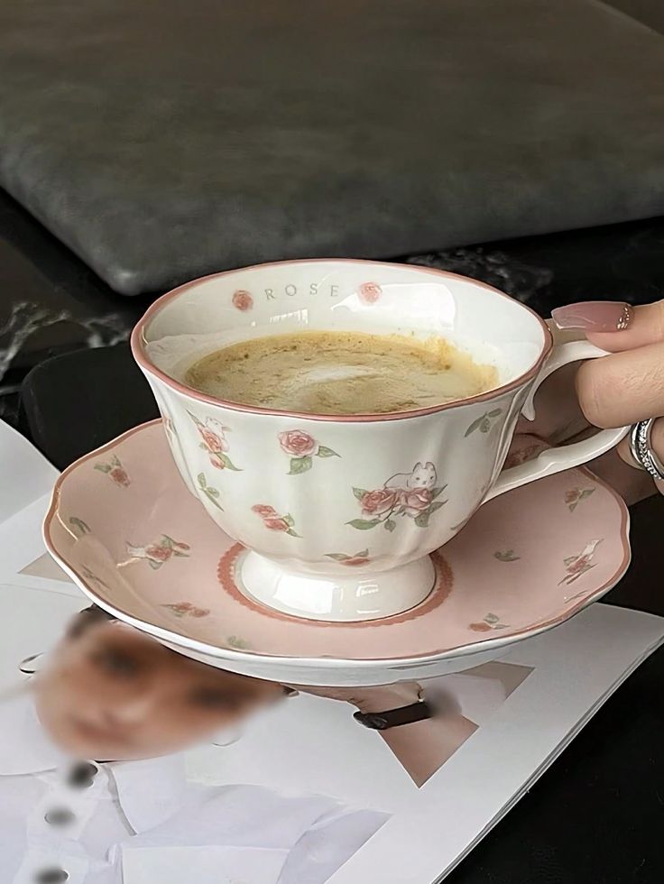 Elegant Floral Tea/Coffee Cup in Cozy Cafe Ambiance