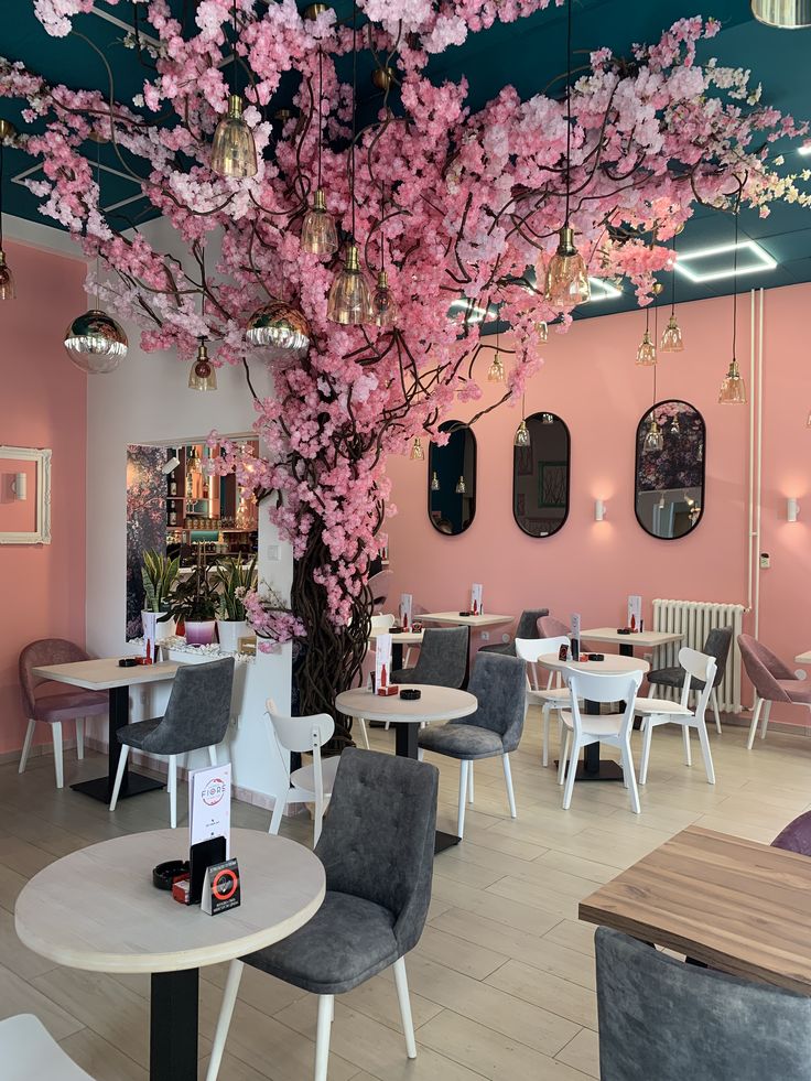 Vibrant Cafe Design Enhanced by Artistic Cherry Blossom Display and Inviting Ambiance