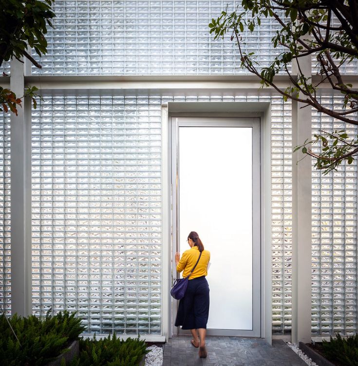 Modern Cafe Design: Inviting Glass Block Entrance Blends Nature with Minimalist Aesthetics