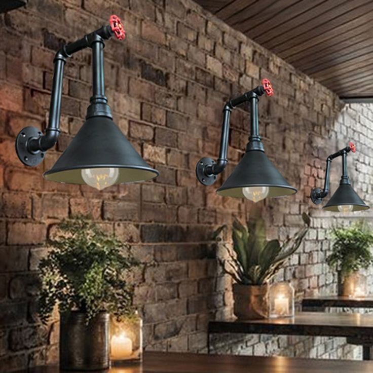 Industrial-Rustic Cafe Design: A Cozy Atmosphere Enhanced by Unique Lighting and Lush Greenery