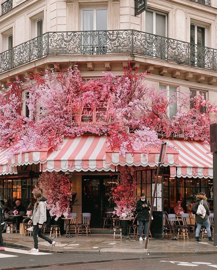 Enchanting Cafe With Vibrant Blossoms and Charming Parisian Architecture