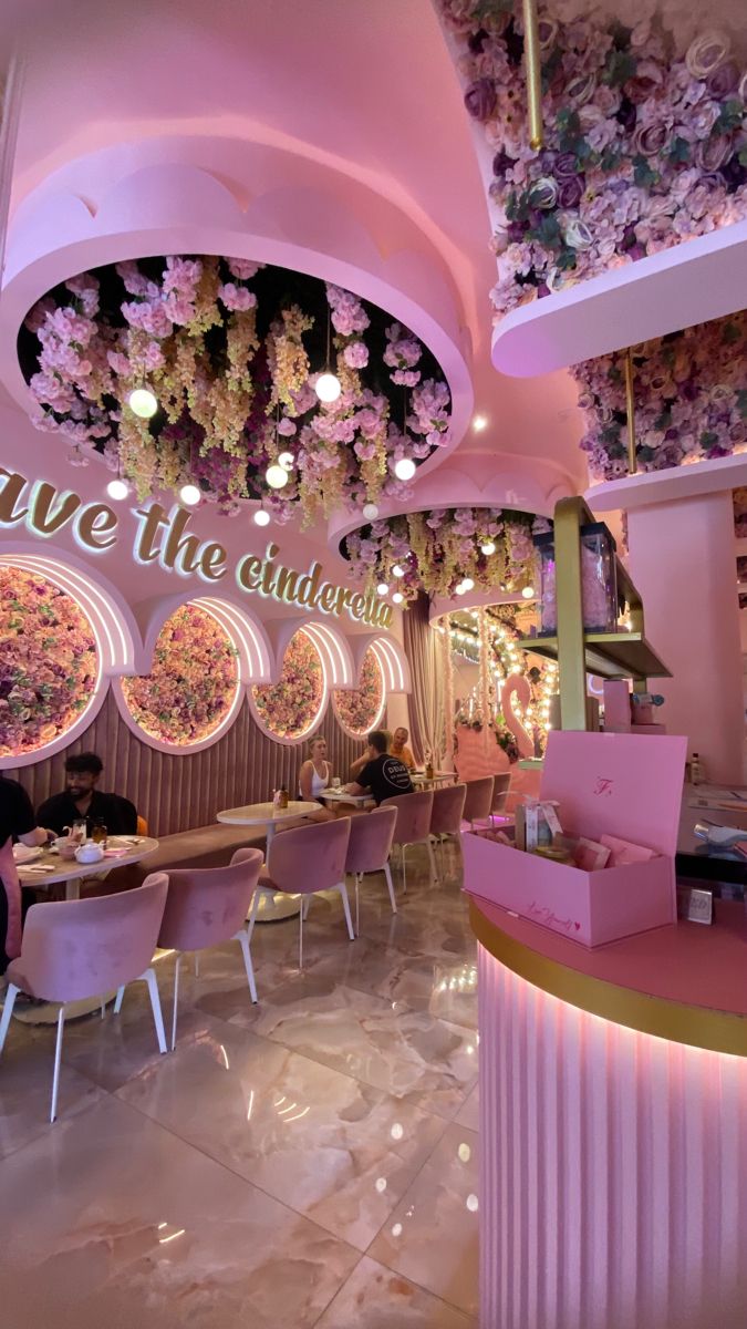 Whimsical Cafe Design: Enchanting Atmosphere with Soft Pink Tones and Floral Arrangements