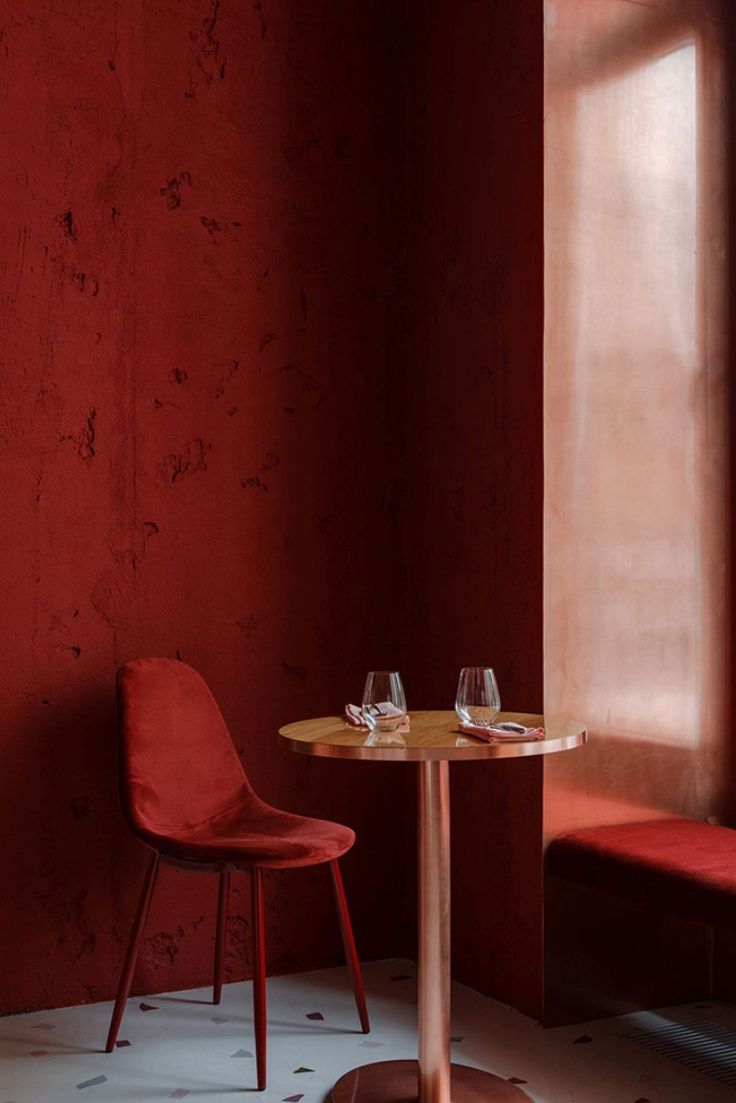 Cozy Cafe Design: Warm Red Tones and Inviting Seating Create an Intimate Atmosphere