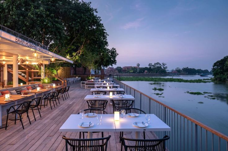 Picturesque Riverside Cafe with Elegant Outdoor Dining and Inviting Atmosphere