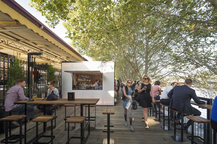 Vibrant Cafe Design Boasts Inviting Outdoor Space and Versatile Seating for Riverside Enjoyment