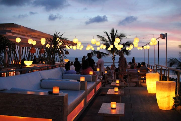 Coastal Cafe Design: Inviting Open-Air Ambiance with Tropical Touches and Stunning Sunset Views