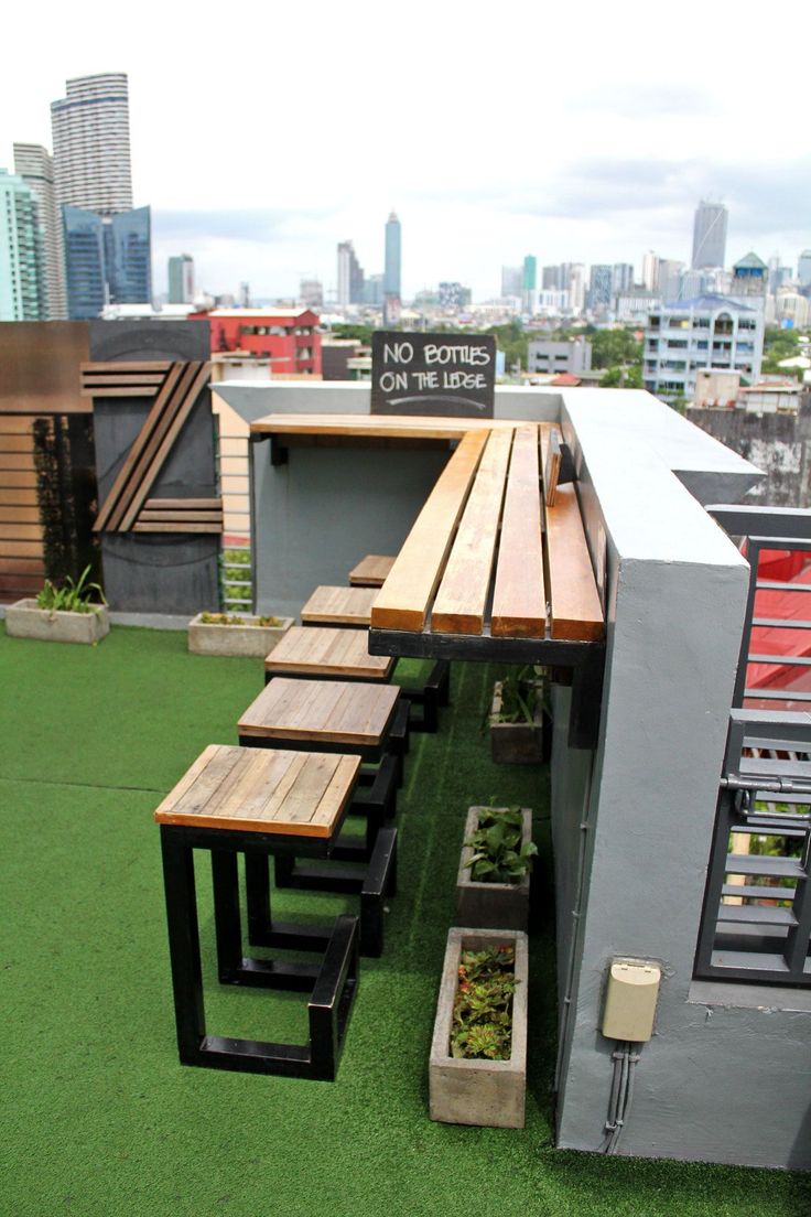 Sleek Rooftop Cafe Design Blends Modern Aesthetics with Interactive Seating and Urban Greenery