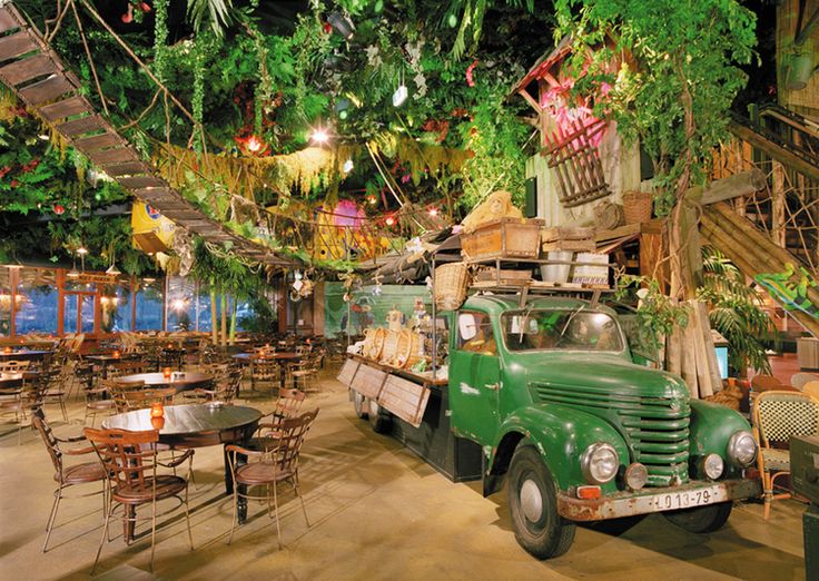 Jungle-Inspired Cafe Design with Lush Greenery and Rustic Charm