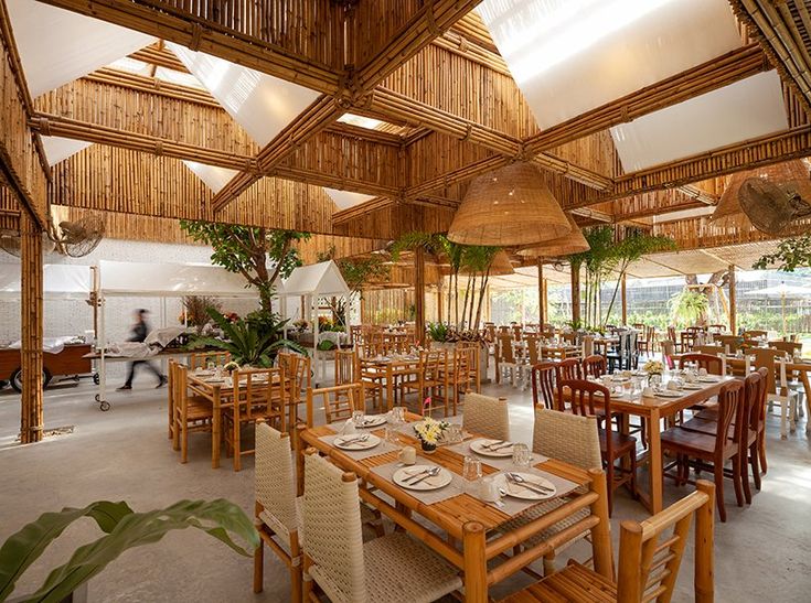 Eco-Friendly Cafe Design: Airy Bamboo Structure and Communal Layout Enveloped in Natural Charm