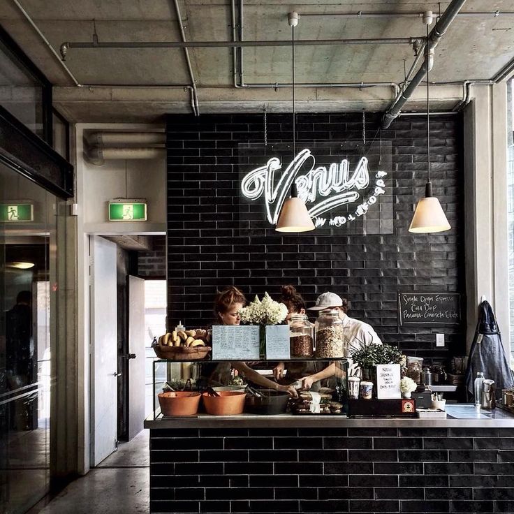 Modern Cafe Design: A Cozy, Industrial Space with Inviting Atmosphere and Natural Light