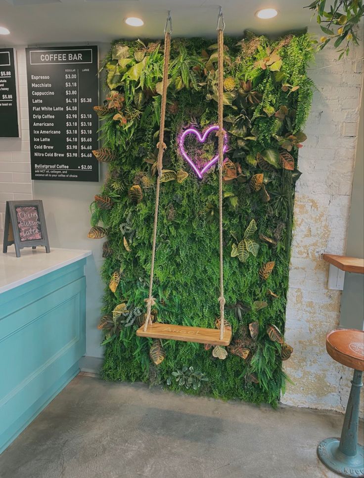 Vibrant Cafe Design Merges Nature and Comfort with Lush Green Wall and Playful Swing