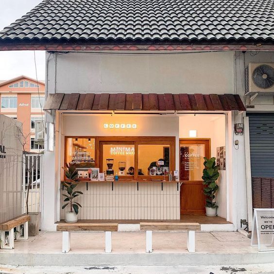 Minimalist Cafe Design: Inviting Facade with Natural Light, Warm Wood Accents, and Cozy Atmosphere