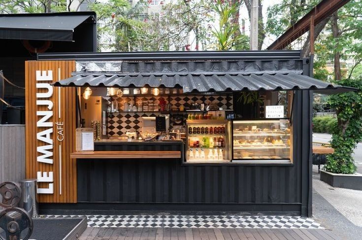 Modern Cafe Design: Striking Container Structure with Inviting Accents and Refreshing Outdoor Ambiance