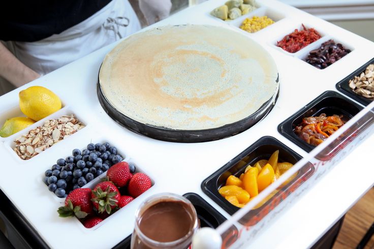 Inviting Cafe Design Features Interactive Crepe Preparation Area with Fresh, Vibrant Ingredients