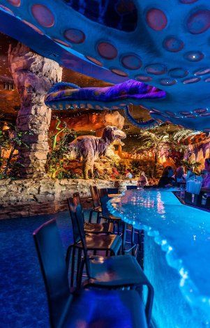 Whimsical Prehistoric Jungle Cafe Design with Interactive Elements and Lush Ambiance