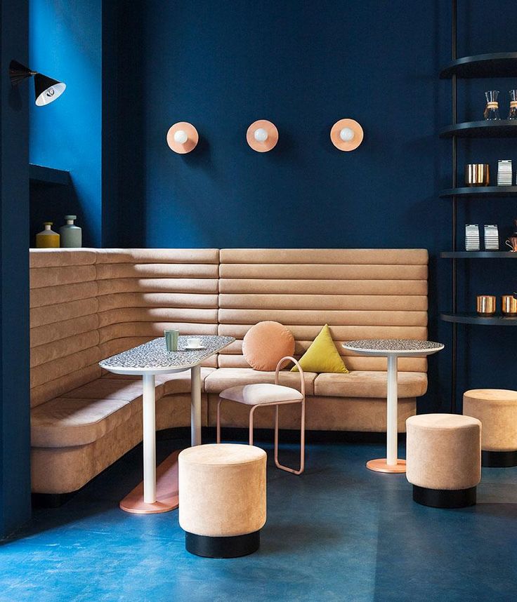 Chic Cafe Design Blends Deep Blue Walls and Warm Beige Furnishings for a Modern Atmosphere