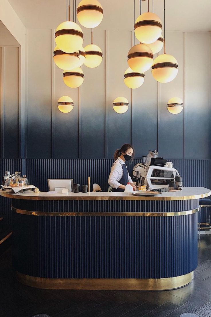 Sleek Modern Cafe Design with Navy Blue and Gold Accents for an Inviting Atmosphere